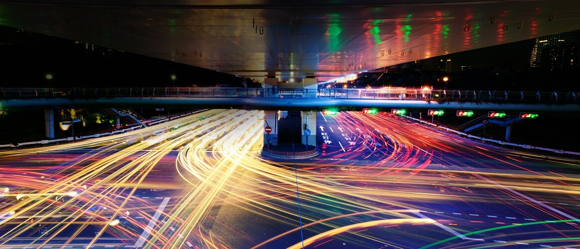 Traffic rushes past on a busy street at night Traffic rushes past on a busy street at night